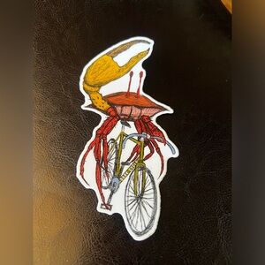 Crab on a bike sticker. 6 inches by 3 inches